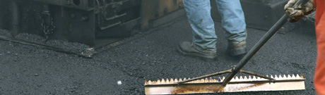 Crew paving a road in asphalt